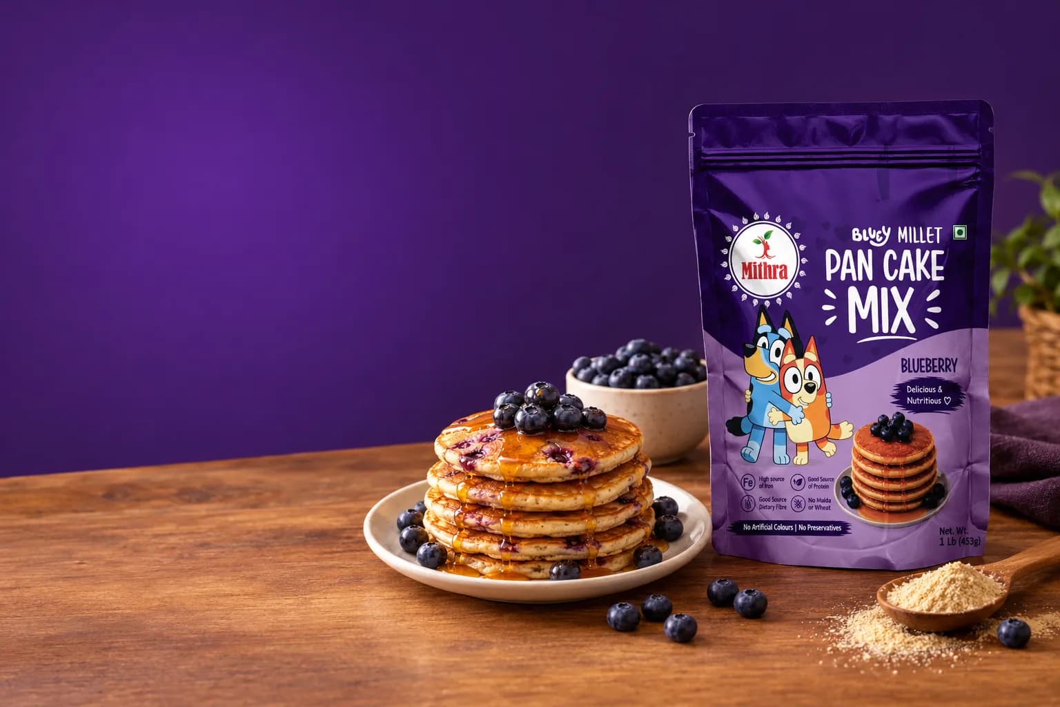 Mithra Bluey Millet Pan Cake Mix, Blueberry, with a stack of blueberry pancakes